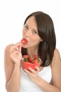 Attractive Healthy Young Woman Eating a Bowl of Fresh Ripe Juicy Strawberries Royalty Free Stock Photo