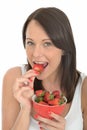 Attractive Healthy Young Woman Eating a Bowl of Fresh Ripe Juicy Strawberries Royalty Free Stock Photo