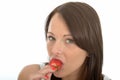 Attractive Healthy Young Woman Eating a Fresh Ripe Juicy Strawberry Royalty Free Stock Photo