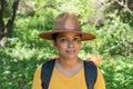 attractive hiker, backpacking, standing outdoors on an autumn day, looking at the camera