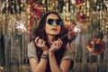 Attractive hipster girl holding sparklers in hands Royalty Free Stock Photo