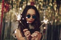 Attractive hipster girl holding sparklers in hands Royalty Free Stock Photo