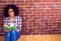 Attractive hipster sitting and reading book Royalty Free Stock Photo