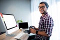 Attractive hipster smiling at camera while working at desk Royalty Free Stock Photo