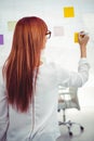 Attractive hipster woman writing on sticky notes Royalty Free Stock Photo