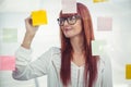 Attractive hipster woman writing on sticky notes Royalty Free Stock Photo