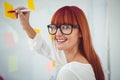 Attractive hipster woman writing on sticky notes Royalty Free Stock Photo