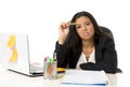 Attractive hispanic businesswoman or secretary suffering breakdown and headache in stress at office Royalty Free Stock Photo