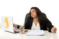 Attractive hispanic businesswoman or secretary suffering breakdown and headache in stress at office Royalty Free Stock Photo