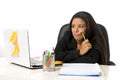 Attractive hispanic businesswoman or secretary suffering breakdown and headache in stress at office Royalty Free Stock Photo