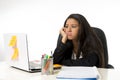 Attractive hispanic businesswoman or secretary suffering breakdown and headache in stress at office Royalty Free Stock Photo