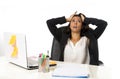 Attractive hispanic businesswoman or secretary suffering breakdown and headache in stress at office Royalty Free Stock Photo