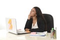 Attractive hispanic businesswoman sitting at office desk working on computer laptop smiling happy Royalty Free Stock Photo