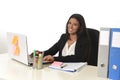 Attractive hispanic businesswoman sitting at office desk working on computer laptop smiling happy