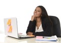 Attractive hispanic businesswoman sitting at office desk working on computer laptop smiling happy Royalty Free Stock Photo