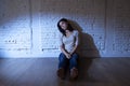 attractive Hispanic woman sitting at home floor frustrated suffe