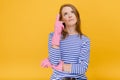 Attractive housewife woman wear rubber cleaning gloves and casual blue striped sweater has good idea in mind, raises fore finger, Royalty Free Stock Photo