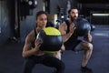 Attractive indian couple doing fitness with medcine ball at gym Royalty Free Stock Photo