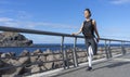 Attractive jogger woman warming the legs before go to running. Athlete runner standing with balance stretch her fit body with Royalty Free Stock Photo