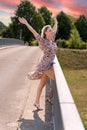 Attractive jubilant blond woman on a bridge