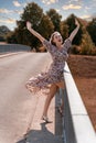 Attractive jubilant blond woman on a bridge