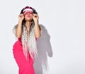 Lady with african dreadlocks pigtails,in pink top hold sun visor, kissing you with closed eyes, posing isolated on white Royalty Free Stock Photo