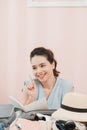 Attractive lady look aside sit on comfort soft cosy carpet rug near couch sofa in modern light house remember list make notes