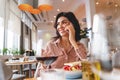 Charming young woman having phone conversation in cafe Royalty Free Stock Photo