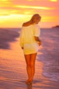 Attractive Lady at the tropical beach in sunset. Royalty Free Stock Photo