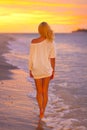 Attractive Lady at the tropical beach in sunset. Royalty Free Stock Photo