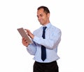 Attractive latin adult man using his tablet pc