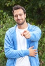 Attractive latin guy pointing at camera in a park Royalty Free Stock Photo