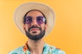 attractive Latin man in casual summer clothes waiting for summer vacation concept studio shot medium closeup orange Royalty Free Stock Photo