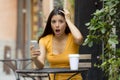 Attractive latin woman shocked on her smart phone Royalty Free Stock Photo