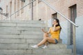 Attractive latin woman listening to music on her smart phone Royalty Free Stock Photo