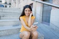 Attractive latin woman listening to music on her smart phone Royalty Free Stock Photo