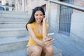 Attractive latin woman listening to music on her smart phone Royalty Free Stock Photo