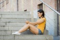 Attractive latin woman listening to music on her smart phone Royalty Free Stock Photo