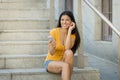 Attractive latin woman listening to music on her smart phone Royalty Free Stock Photo