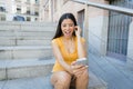 Attractive latin woman listening to music on her smart phone Royalty Free Stock Photo