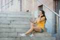 Attractive latin woman listening to music on her smart phone Royalty Free Stock Photo