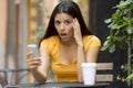 Attractive latin woman shocked on her smart phone Royalty Free Stock Photo