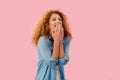 Laughing redhead woman Isolated On pink