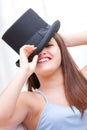 Attractive laughing young woman wearing a top hat Royalty Free Stock Photo