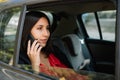 Attractive lawyer talking on phone in car