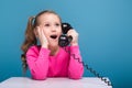 Attractive little cute girl in pink shirt with monkey and blue trousers hold empty poster and talks a phone Royalty Free Stock Photo