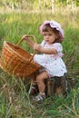 Attractive little girl holding a basket