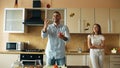 Attractive loving couple having fun in the kitchen. Handsome man juggle with apples to impress his girlfriend Royalty Free Stock Photo