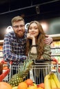 Attractive Loving couple standing near the shopping trolley Royalty Free Stock Photo