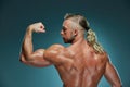 Attractive male body builder on blue background Royalty Free Stock Photo